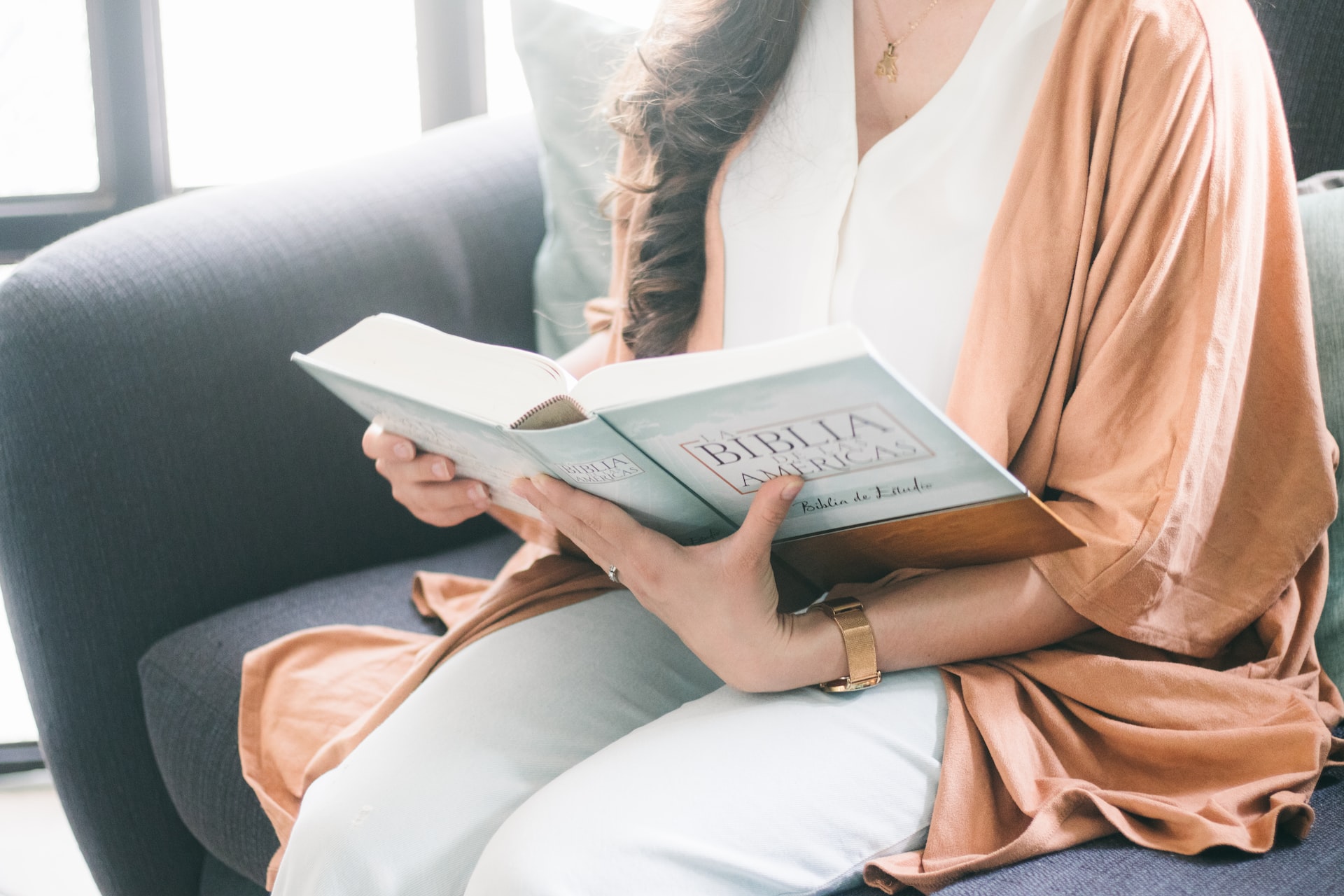 woman in brown robe reading book